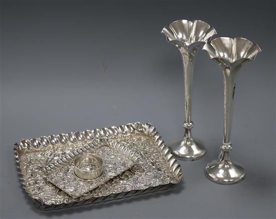 Two late 19th/early 20th century repousse silver trays, a pair of silver spill vases and a silver napkin ring.